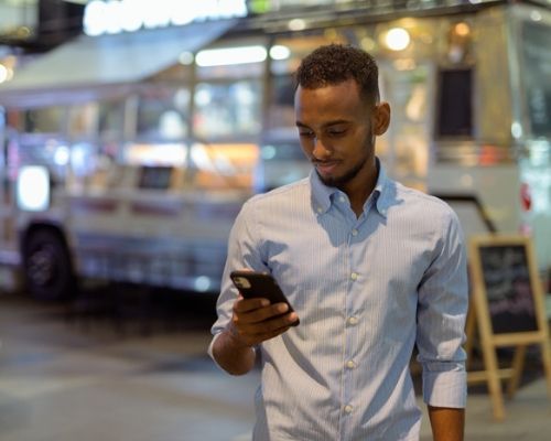 somali guy holding phone